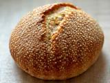 A seeded sourdough loaf, crusted with various seeds like flax, sesame, and sunflower.